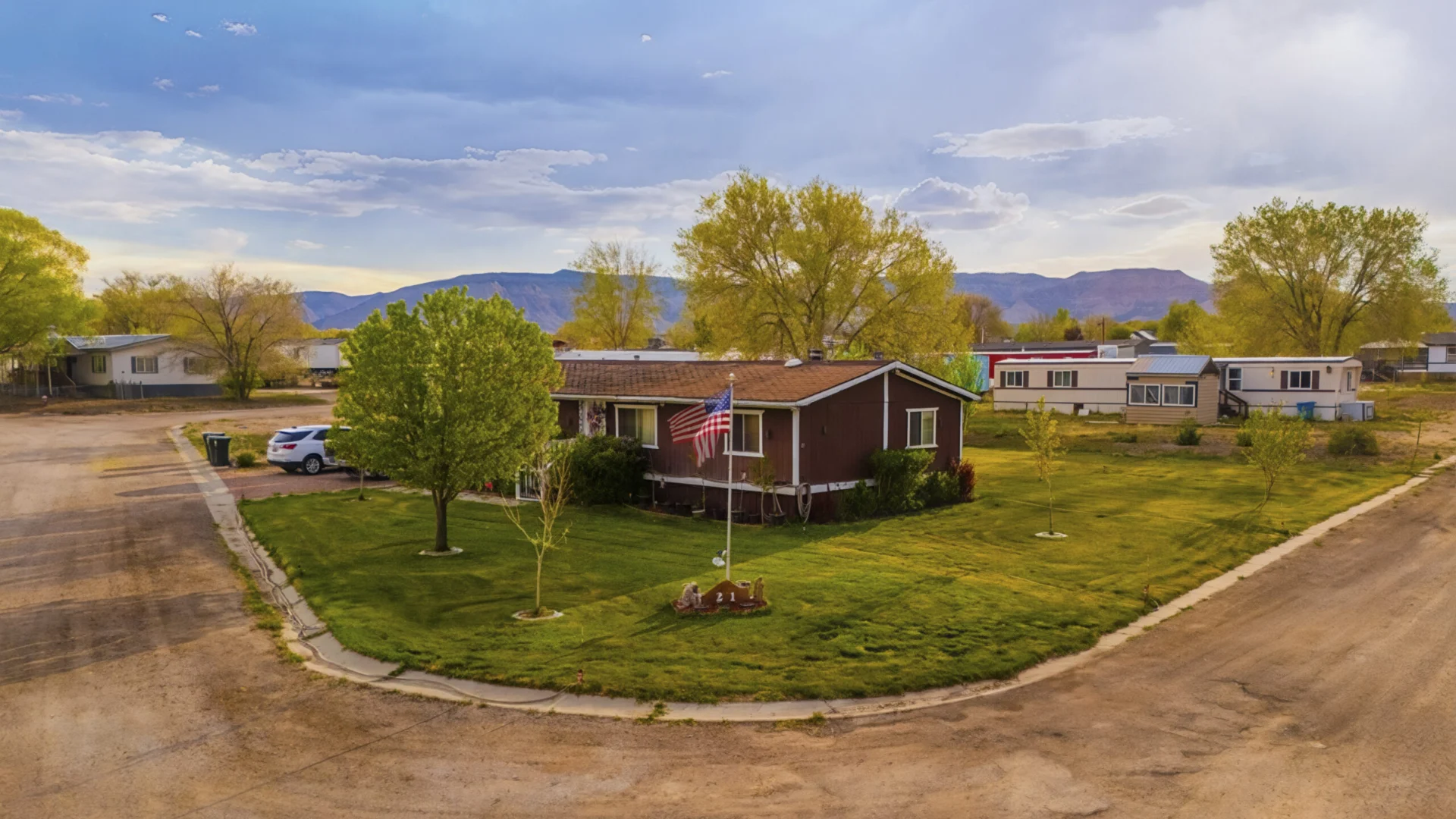 Aerial view of RV park homes and mountain scenery in Castle Dale, Utah